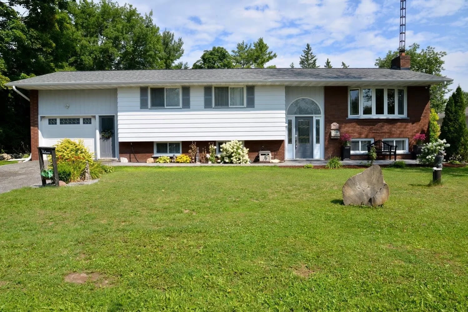 Alexander House with a green front lawn and mature trees